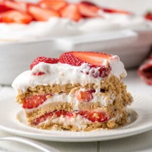 A slice of gluten-free strawberry icebox cake on a white plate.